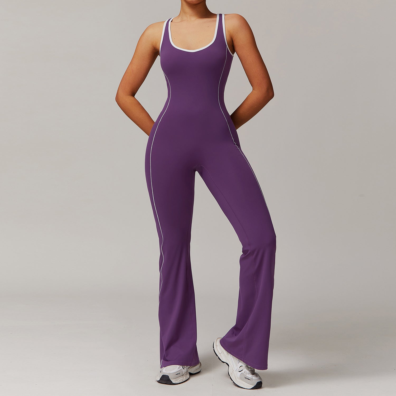 Purple athletic jumpsuit with white trim for fashionable yoga and activewear enthusiasts