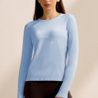 Light blue long-sleeved knit sweater, a stylish choice in ملابس for fitness enthusiasts