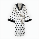 Elegant white bathrobe with black bow patterns and lace trim for fashionable loungewear