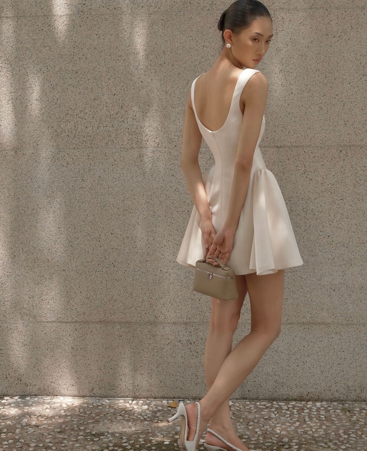 Woman in a white dress and handbag showcasing Beautiful Tight Waist a Swing Sling Dress fashion