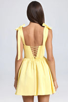 Yellow mini dress with tie straps and corset back, perfect for trendy langry fashion