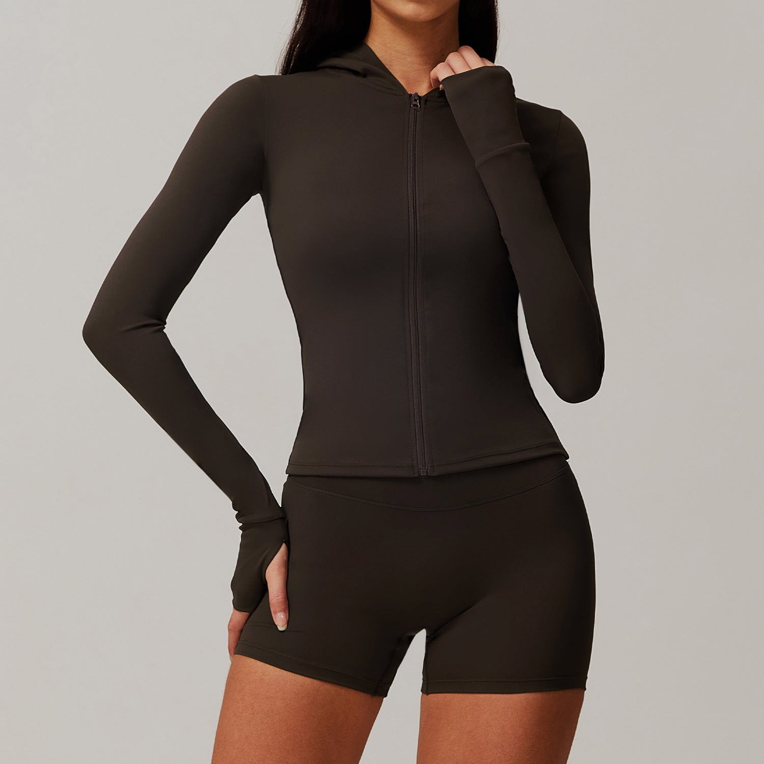 Black long-sleeved athletic crop top and shorts workout set for stylish fitness fashion