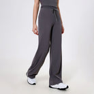 Gray wide-leg athletic pants with drawstring waist and white sneakers in fashion ملابس