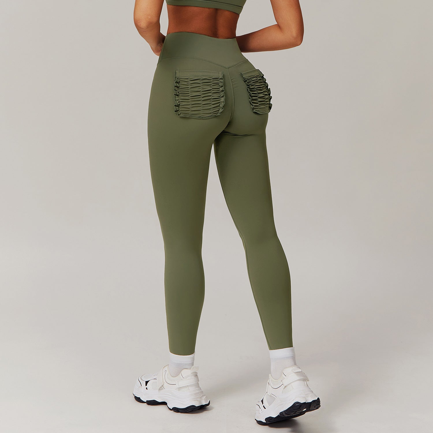 Olive green leggings with ruched back pockets, ideal for casual fashion or active wear