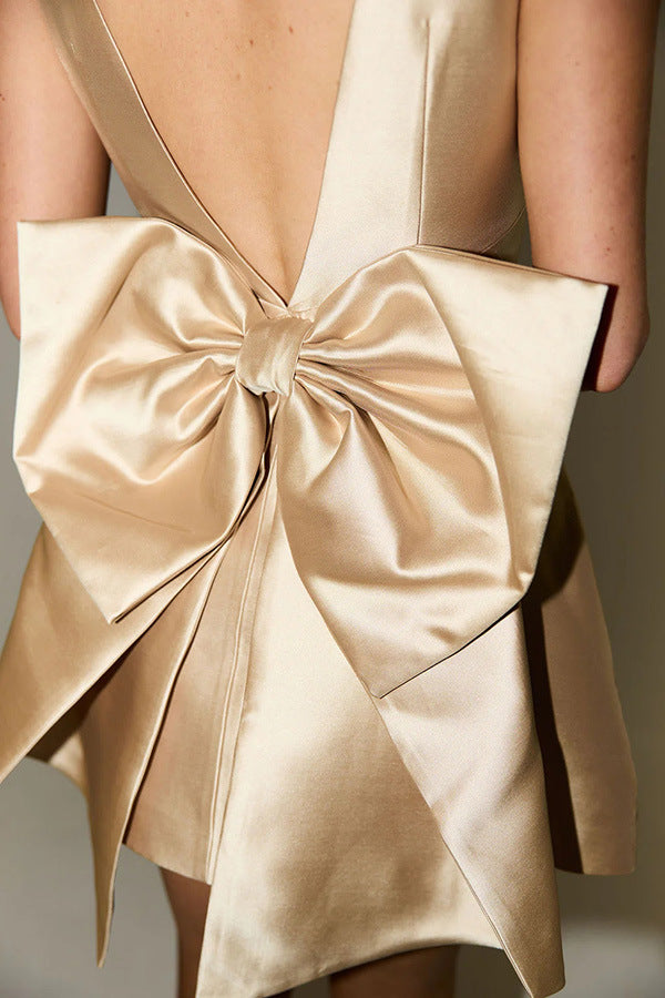 Champagne-colored satin bow on fabric of Captivating Bow Decorative Dress, elegant fashion ملابس