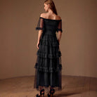 Black off-shoulder tiered tulle evening dress showcasing refined fashion in ملابس