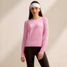 Pink long-sleeved athletic top and black leggings for stylish langry fitness wear