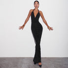 Sleek black halter-neck evening gown with plunging neckline, perfect for fashion lovers