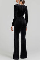 Black velvet jumpsuit with long sleeves and flared legs, ideal for langry fashion ملابس