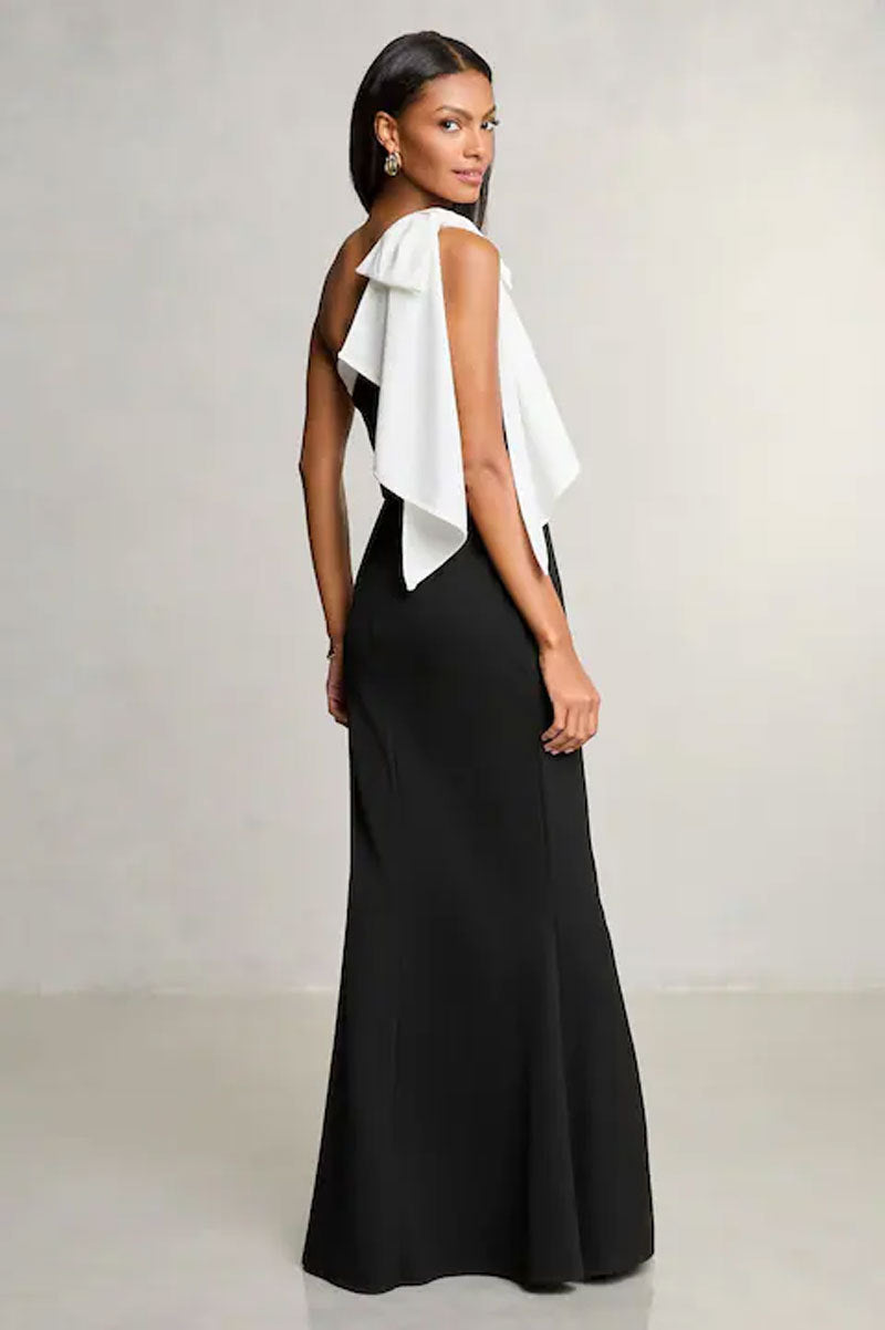 Elegant black and white evening gown with ruffled back, perfect for fashion or ملابس