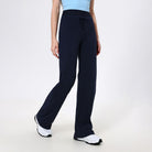 Navy blue wide-leg athletic pants paired with white sneakers for stylish fitness fashion