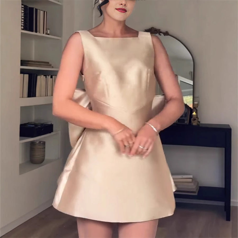 Sleeveless cream satin cocktail dress with flared skirt for elegant fashion ملابس