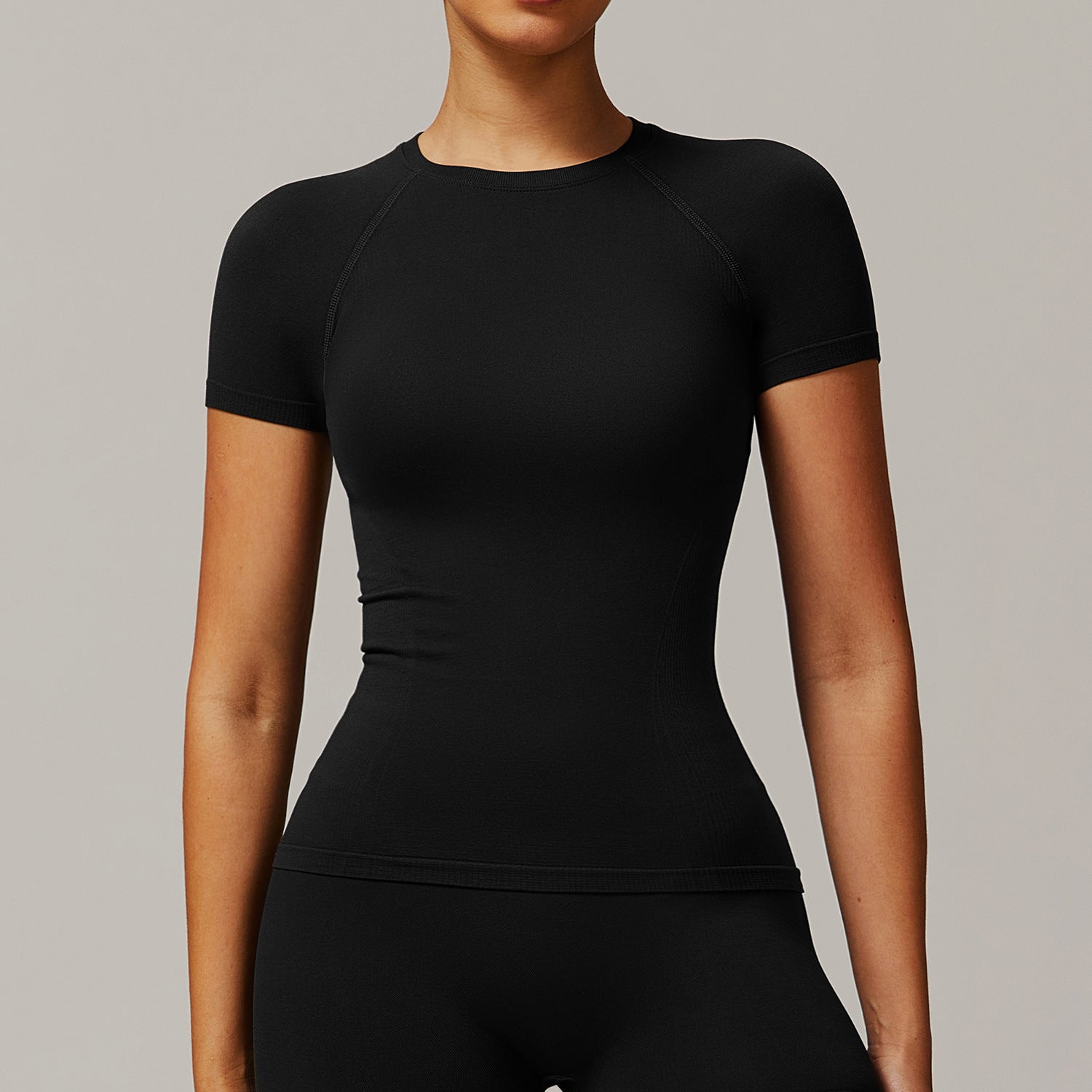 Form-fitting black short-sleeved top from Thread Seamless, ideal for yoga and fashion