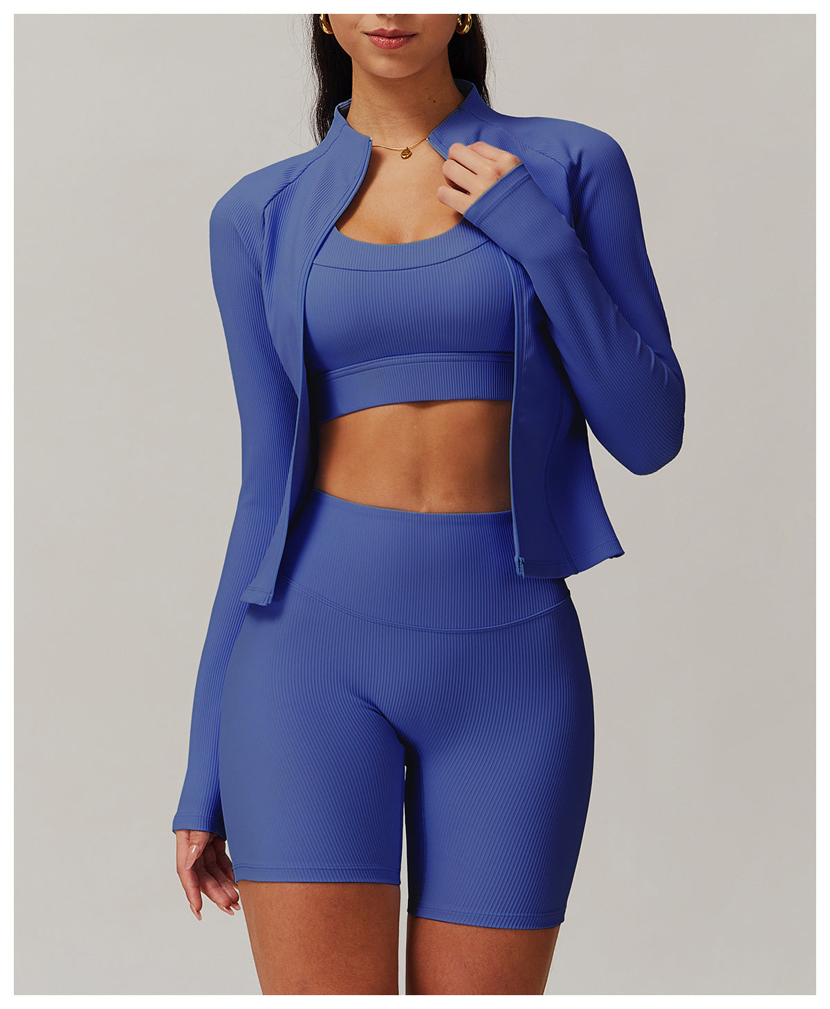 Royal blue three-piece athletic set featuring a zip-up jacket, sports bra, and fitted shorts