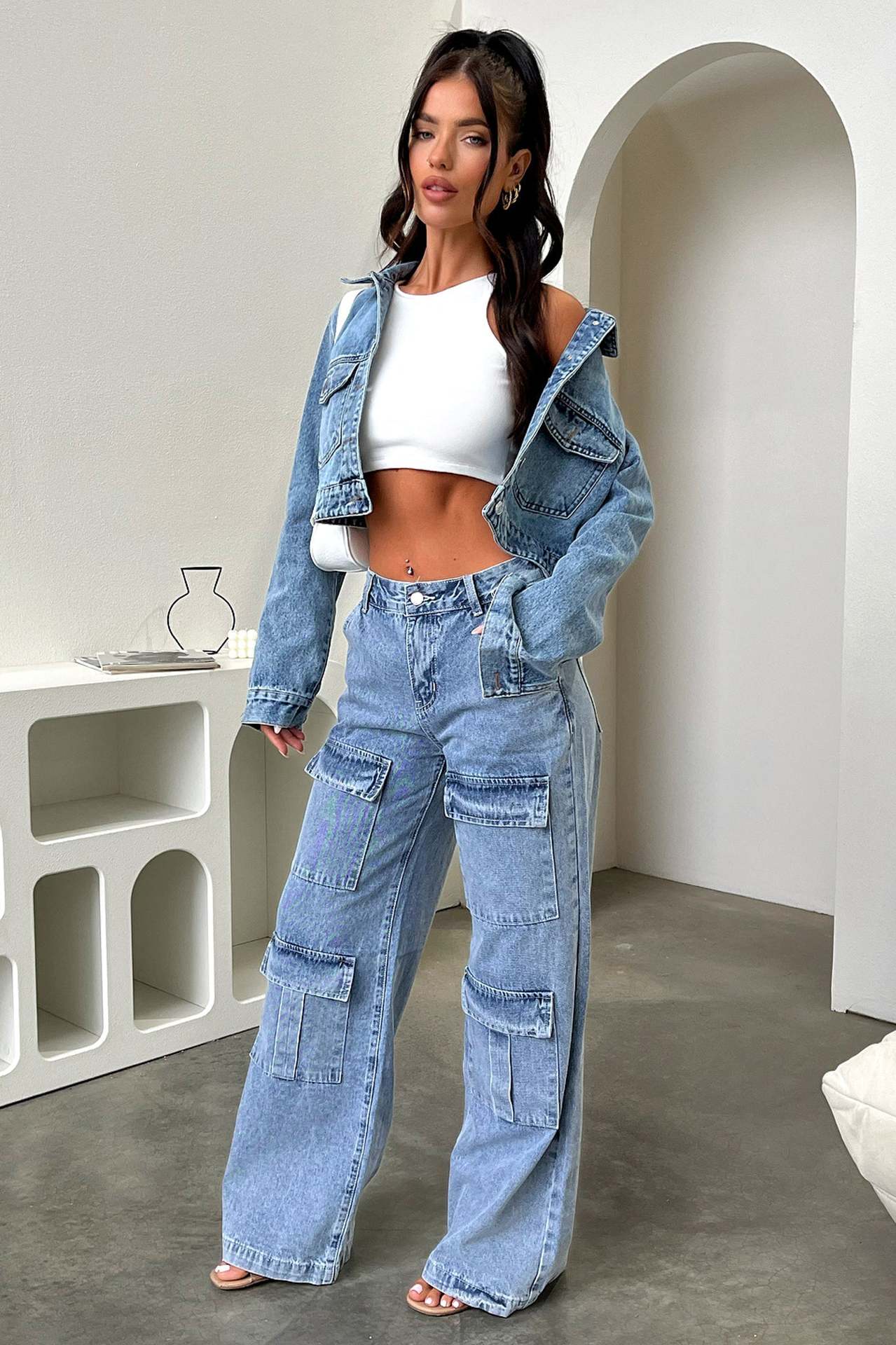 Matching denim jacket and wide-leg cargo jeans styled with a white crop top for fashion