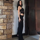 Person in black crop top and high-waisted pants showcasing elegant langry fashion