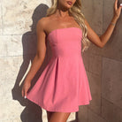 Pink strapless mini dress with pleated skirt, perfect for fashionable occasions and langry style