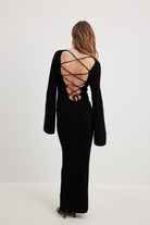 Long black dress with laced-up open back design, ideal for langry fashion ملابس