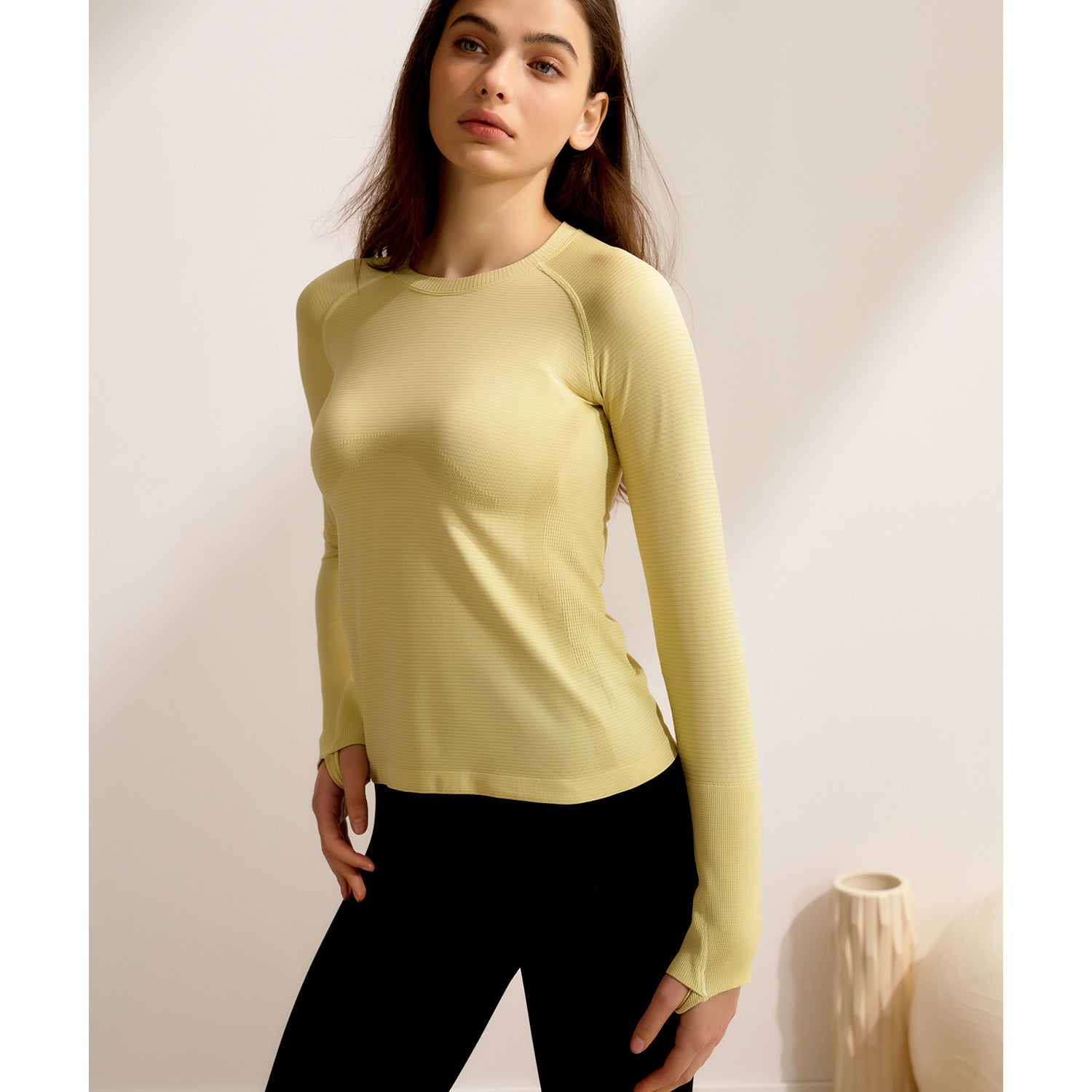 Pale yellow long-sleeved langry for fitness, featuring a crew neckline and quick drying design