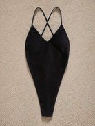 Black ribbed one-piece swimsuit with crossed back straps for stylish summer fashion