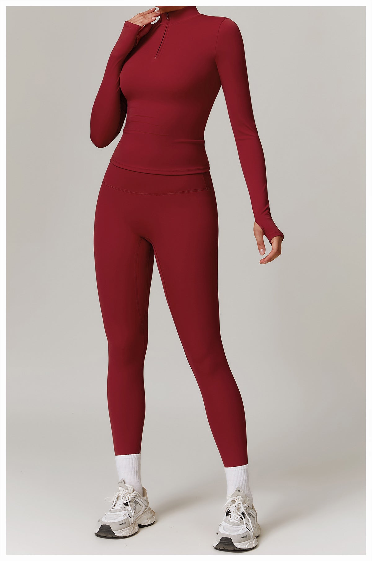 Burgundy long-sleeved athletic jumpsuit with socks and sneakers for outdoor fitness