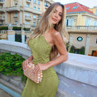 Woman in green Beautiful Slim Fit Long Ribbon Dress showcasing a pearl clutch in fashion