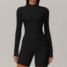 Black long-sleeved bodysuit with fitted shorts, a trendy option in ملابس and langry fashion