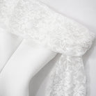 White lace trim on a white fabric sleeve of an Elegant A Line Dress in fashion