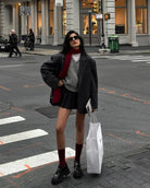 Person in winter fashion outfit with Loose Knit Vest Sweater and shopping bag