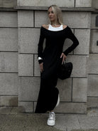 Long black dress with white trim and casual sneakers for stylish fashion ملابس