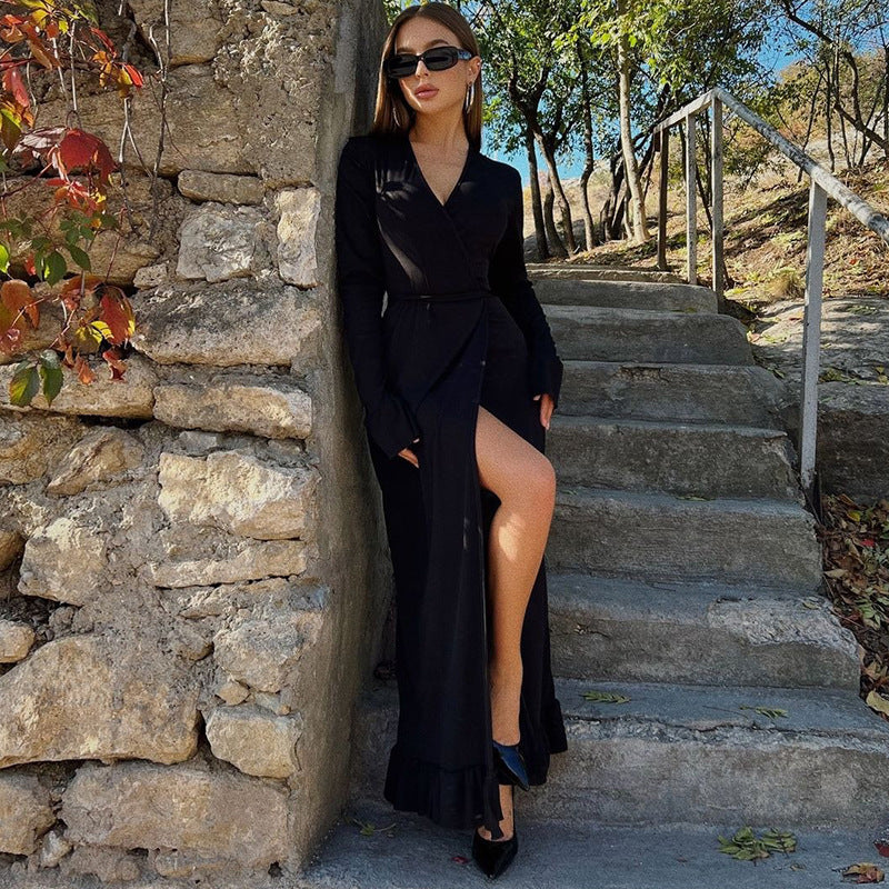 Elegant black wrap dress with thigh-high slit and long sleeves, perfect for stylish fashion