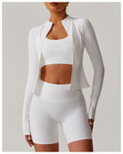 White athletic three-piece langry set includes cropped jacket, sports bra, and shorts