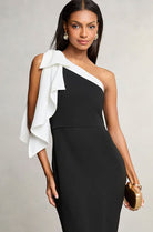 Elegant one-shoulder black cocktail dress with white ruffle, perfect for modern fashion ملابس