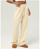 Cream-colored sweatpants with elastic waistband and straight-leg design for casual fitness