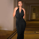 Sleek black halter dress with ruched detailing showcasing modern fashion and style