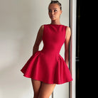 Sleeveless red fit-and-flare mini dress featuring a pleated skirt for stylish fashion