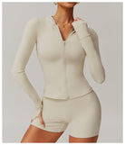 Cream-colored zip-up workout romper with long sleeves, shorts, ideal for fashionable langry ملابس