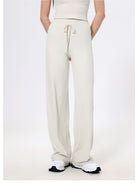 Cream-colored drawstring sweatpants with straight-leg styling for fashionable comfort in ملابس