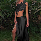 Woman in black floral top and high-slit skirt showcasing Elegant Lace up Top Split Skirt Two Piece Sets fashion