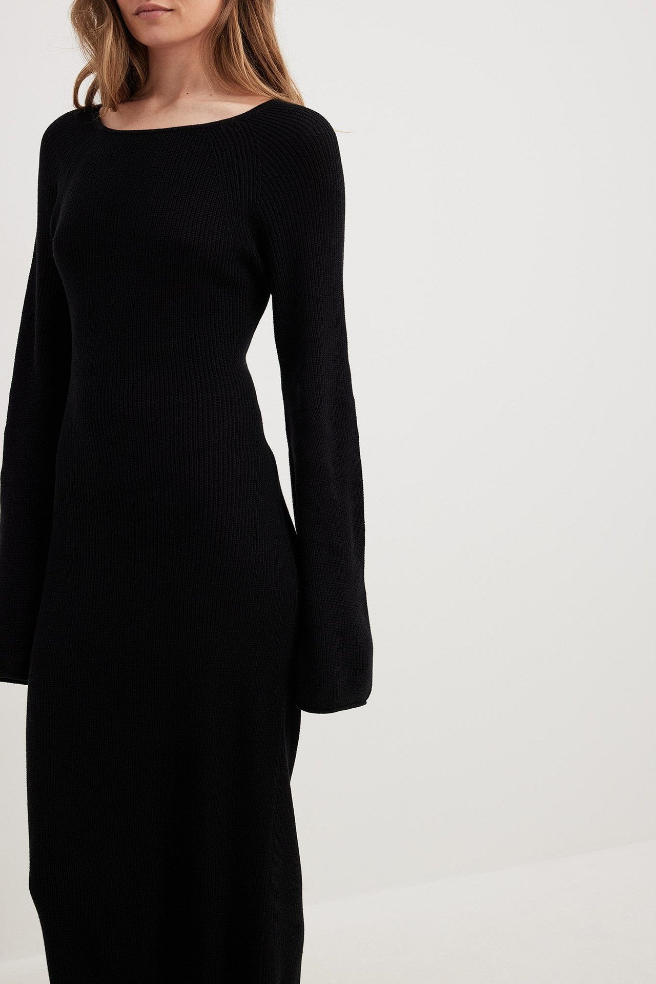 Black knit dress with long bell sleeves, ideal for fashionable langry ملابس outfits