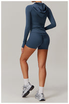 Navy blue hooded workout romper for women, featuring long sleeves and shorts in fashion ملابس