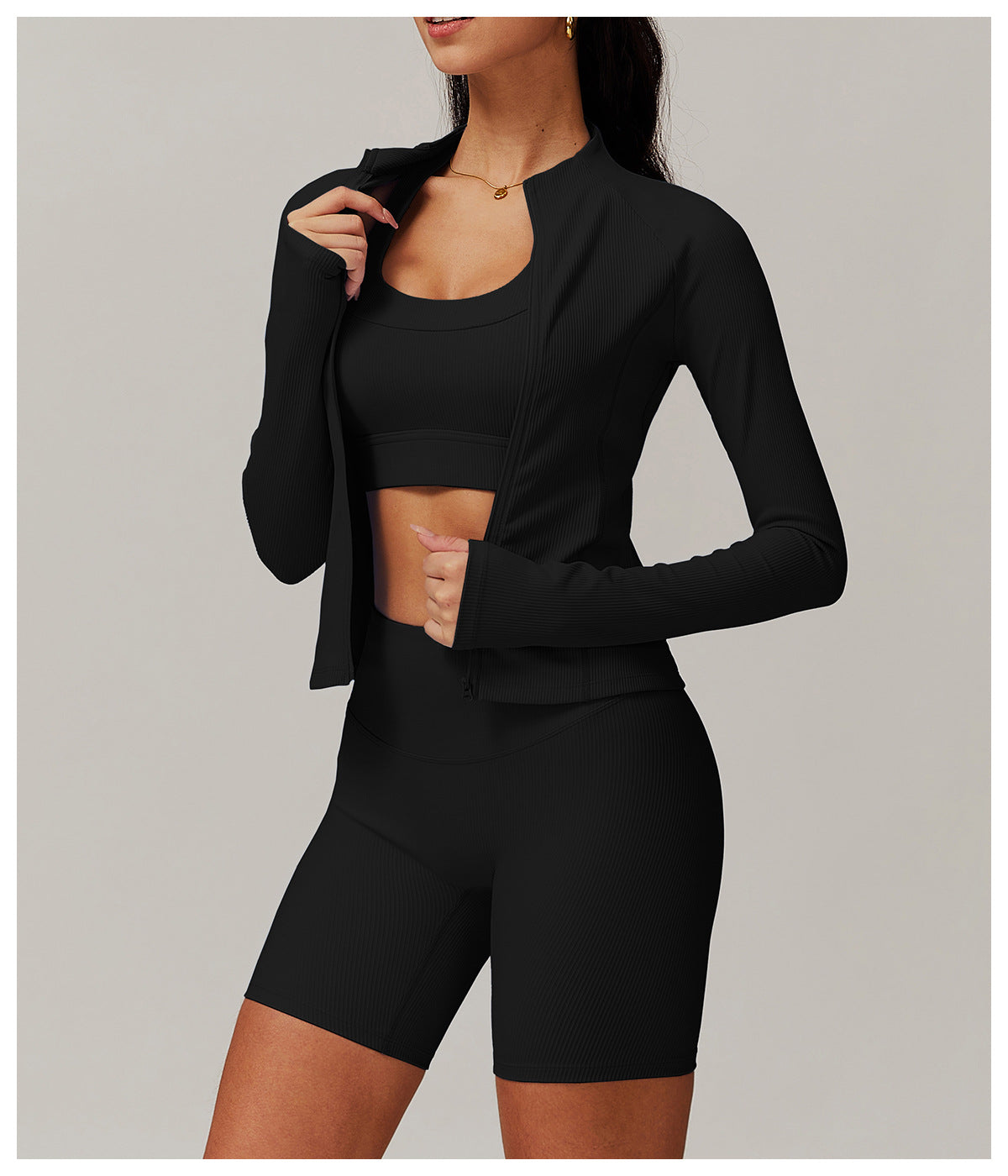 Black athletic two-piece langry workout set featuring a cropped jacket and fitted shorts