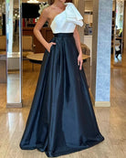 Elegant evening gown with white top and navy blue skirt, ideal for fashion occasions