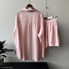 Pink silk pajama set featuring a breathable sun protection shirt and shorts on display