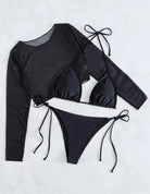 Three-piece black swimsuit set consisting of a long-sleeved top, triangle bikini top, and tie-side bikini bottom.