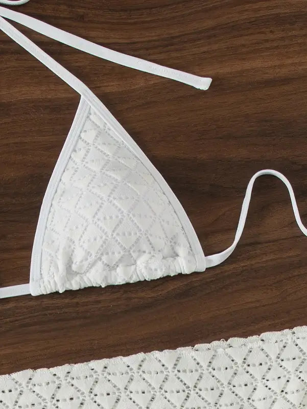 White crochet triangle bikini top with tie straps.