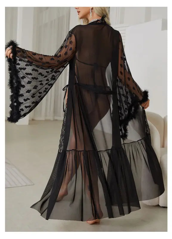 Sheer black robe with wide sleeves, polka dot pattern, and feathered trim.