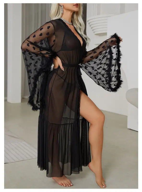 Sheer black robe with heart patterns and wide bell sleeves.