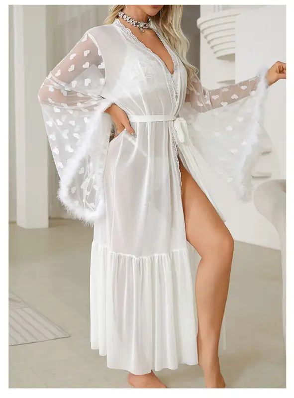 White sheer robe with heart-patterned sleeves and a belted waist.