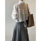 White button-down blouse with billowy sleeves styled with black midi skirt from Comfy Sunrise Cardigan